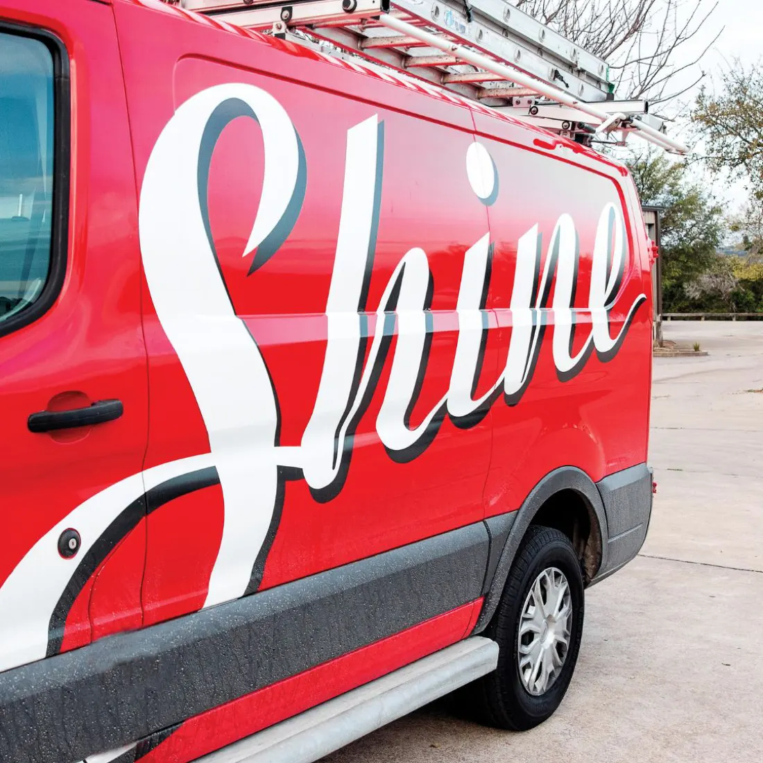 A red Shine van with the script logo on the side
